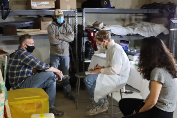 Researchers in a discussion in a storage room