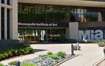 A building with a silver sculpture in front that says "MIA"